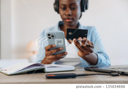 Credit card, online payment. Woman is at home in domestic room Credit card, online payment. Woman is at home in domestic room 135834698