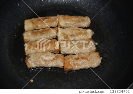 Meat rolls fried in a frying pan Meat rolls fried in a frying pan 135834701