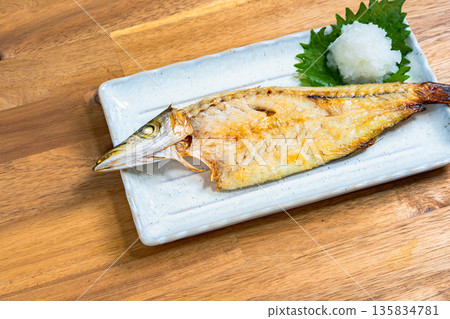 Grilled barracuda with salt Japanese style grilled fish served with grated daikon radish and shiso leaves 135834781