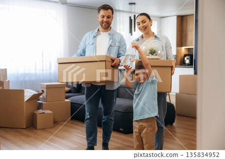 Bunch of boxes. Family of husband, wife and son are moving into new house 135834952