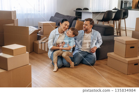 Finally some rest. Family of husband, wife and son are moving into new house Finally some rest. Family of husband, wife and son are moving into new house 135834984