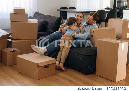 Finally some rest. Family of husband, wife and son are moving into new house Finally some rest. Family of husband, wife and son are moving into new house 135835020