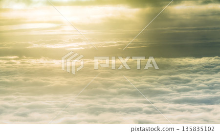 Aerial view of a sea of clouds shining in the setting sun Aerial view of a sea of clouds shining in the setting sun 135835102