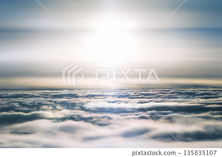 Aerial view of a sea of clouds shining in the setting sun 135835107