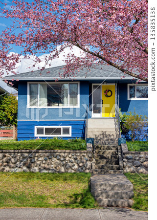 Average single family house with front yard on land terrace. 135835138