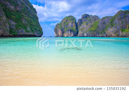 Spectacular resort scenery of Maya Beach on Phi Phi Island in Thailand, with its emerald green sea and limestone cliffs Spectacular resort scenery of Maya Beach on Phi Phi Island in Thailand, with its emerald green sea and limestone cliffs 135835192