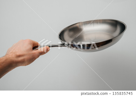 Stainless steel frying pan waiting on a kitchen countertop, ready to be used for cooking, close up Stainless steel frying pan waiting on a kitchen countertop, ready to be used for cooking, close up 135835745