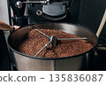 Industrial coffee roasting machine with cooling drum full of fresh beans  135836087