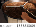 The cooling drum of industrial roasting coffee machine. Roasted beans cooling in the drum after roasting. 135836089