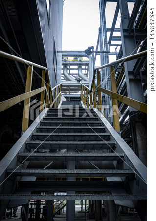 Staircase in a building with a yellow railing Staircase in a building with a yellow railing 135837345