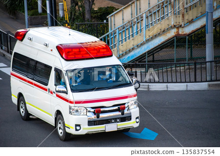 An ambulance driving through an intersection An ambulance driving through an intersection 135837554
