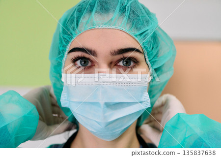 Medical Professional Wearing Surgical Mask and Cap in Clinical Setting for Safety and Care Today Medical Professional Wearing Surgical Mask and Cap in Clinical Setting for Safety and Care Today 135837638
