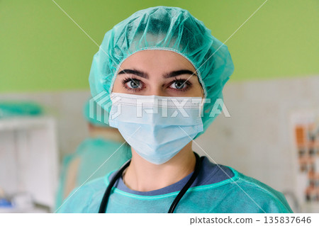 Compassionate Medical Professional Wearing Mask And Surgical Cap In Hospital Setting During Clinical Care Shift Compassionate Medical Professional Wearing Mask And Surgical Cap In Hospital Setting During Clinical Care Shift 135837646