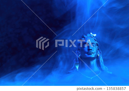 Maha Shivratri background. Adiyogi shiva statue meditating in blue mystical smoke 135838857