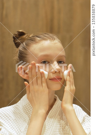 Cute Teen Girl Applies Cleansing Foam to Face in Front Mirror in Modern Bathroom. Blonde Caucasian Gen Alpha Girl Washing Face. Skincare routine for youthful, healthy skin. Beauty Routine. Cute Teen Girl Applies Cleansing Foam to Face in Front Mirror in Modern Bathroom. Blonde Caucasian Gen Alpha Girl Washing Face. Skincare routine for youthful, healthy skin. Beauty Routine. 135838879