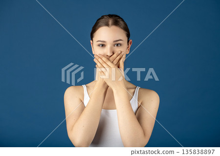 Woman covering mouth keeping secret or silence 135838897