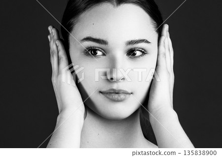 Woman covering ears ignoring disturbing noise or gossip Woman covering ears ignoring disturbing noise or gossip 135838900