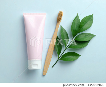 Personal care products. Minimalistic bamboo toothbrush with a tube of natural toothpaste on a white background. Health care. Oral hygiene. Personal care products. Minimalistic bamboo toothbrush with a tube of natural toothpaste on a white background. Health care. Oral hygiene. 135838966