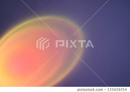 Abstract purple background showing soft glowing orange and pink light halo 135839354