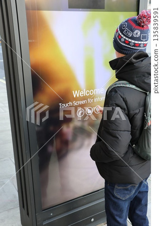 A man is looking at a screen that says "welcome" A man is looking at a screen that says "welcome" 135839591