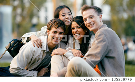Diverse students smiling together enjoying outdoor community Diverse students smiling together enjoying outdoor community 135839779