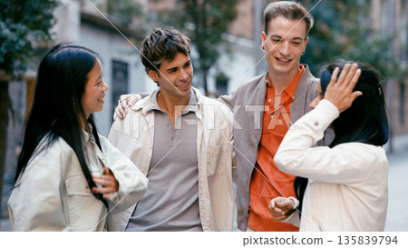 Diverse friends walking and talking on city street Diverse friends walking and talking on city street 135839794