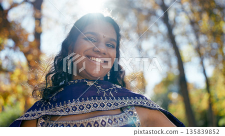 Smiling indian woman wearing traditional sari outdoors Smiling indian woman wearing traditional sari outdoors 135839852