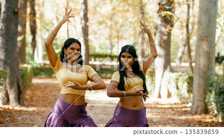 Indian women performing traditional indian dance outdoors 135839859