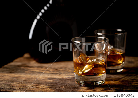 Whiskey with ice in glasses Whiskey with ice in glasses 135840042