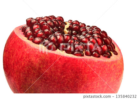 A pomegranate fruit with a hole in the middle 135840232