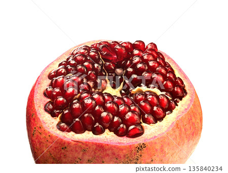 A pomegranate fruit with a hole in the middle A pomegranate fruit with a hole in the middle 135840234