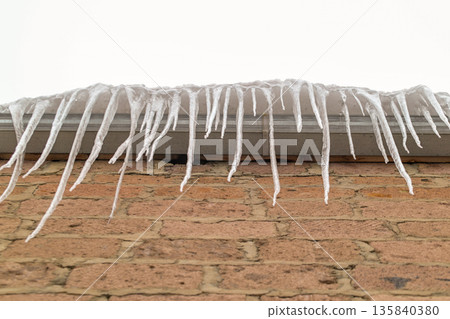 A brick wall covered in icicles A brick wall covered in icicles 135840380