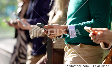 People interacting with smartphones showing technology addiction People interacting with smartphones showing technology addiction 135840444