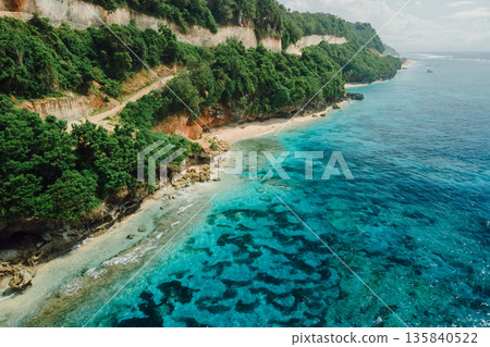 Beach under cliffs with quiet ocean in Bali. Aerial view Beach under cliffs with quiet ocean in Bali. Aerial view 135840522