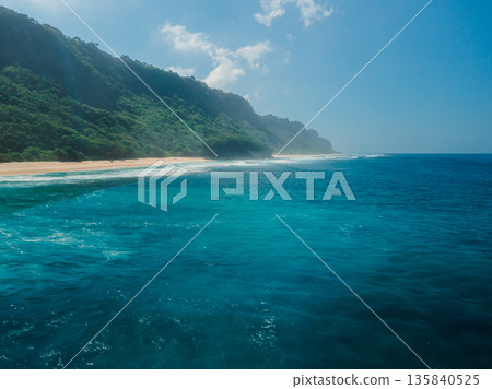 View of coastline with green hills in Bali. Nyang Nyang beach View of coastline with green hills in Bali. Nyang Nyang beach 135840525