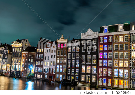 Amsterdam city at night. Old water canal houses in Netherlands 135840643