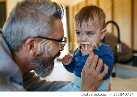 Father with little toddler son at home. Father with little toddler son at home. 135840734