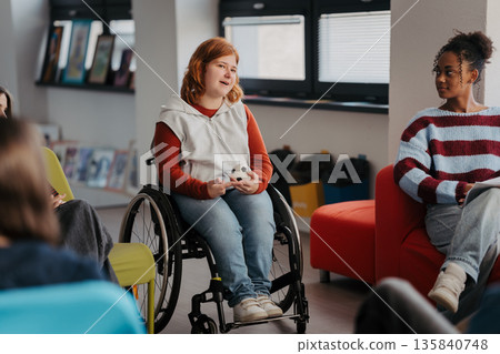 Teen students talking together in inclusive school setting. 135840748