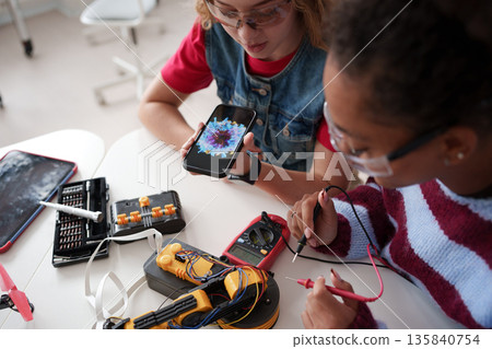 High school students working on robotics project, using online AI app to answer questions. High school students working on robotics project, using online AI app to answer questions. 135840754