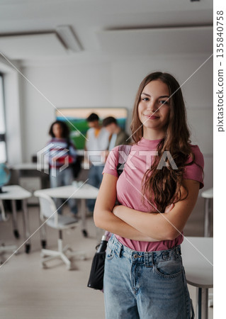 Confident teen student standing in modern classroom. 135840758