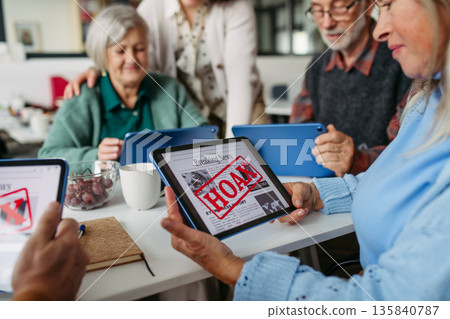 Tutor teaching seniors about scams and online risks. Tutor teaching seniors about scams and online risks. 135840787
