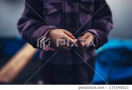 Close up on hands of young fisherman. Close up on hands of young fisherman. 135840821