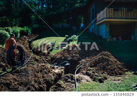 Installing underground utility shaft during construction work. 135840829