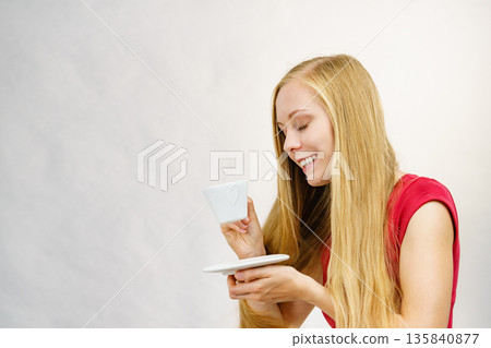 Blonde girl with coffee cup Blonde girl with coffee cup 135840877