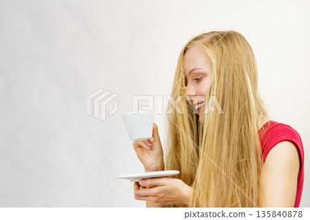 Blonde girl with coffee cup Blonde girl with coffee cup 135840878