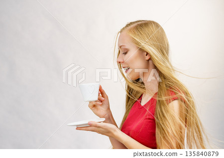 Blonde girl with coffee cup Blonde girl with coffee cup 135840879