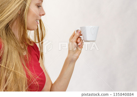 Blonde girl with coffee cup Blonde girl with coffee cup 135840884