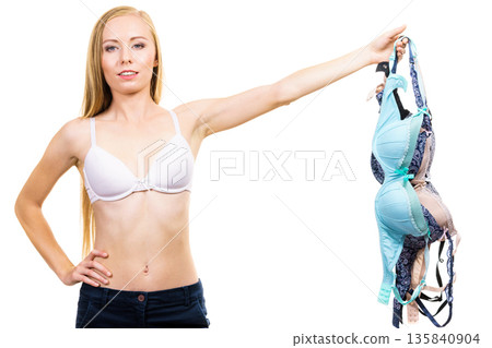 Woman holds bras, choosing Woman holds bras, choosing 135840904