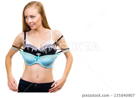 Woman holds bras, choosing Woman holds bras, choosing 135840907