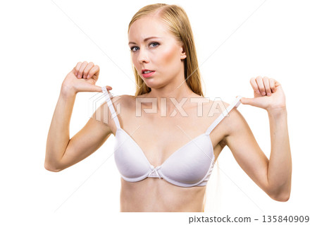 Young woman holding bra strap Young woman holding bra strap 135840909